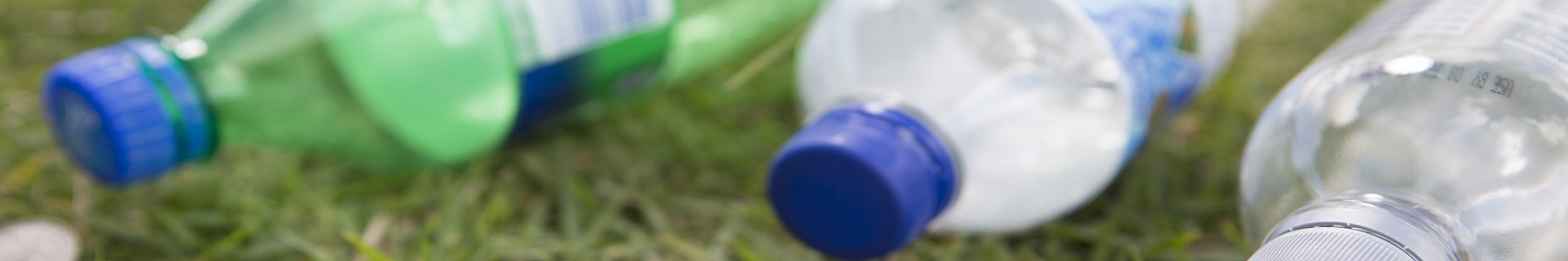 Recyclable bottles on grass
