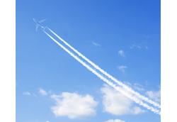 Condensation Trails of a plane in the sky, surrounded by clouds