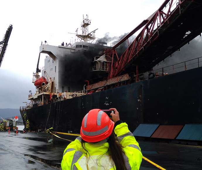 Officer photographing fire on the Iron Chieftan