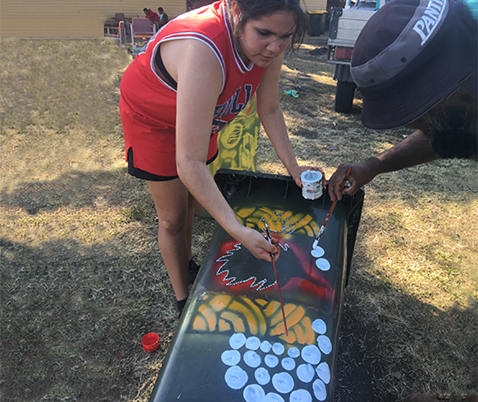 Muli Muli Community members painting recycling bin