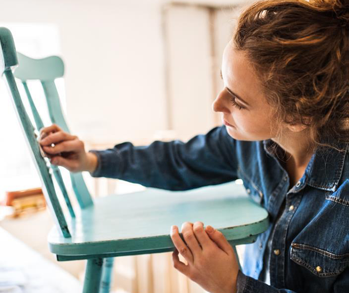 woman sanding a chair