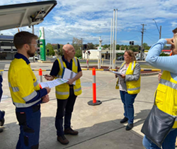 a man in hard hat and hi viz vest inspecting a gas pipeline