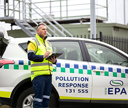 EPA officer beside a car branded EPA pollution response