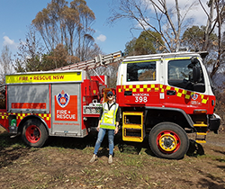 staff member in hi vis in front of a fire truck