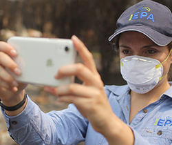 woman wearing a mask taking photos