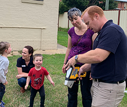 EPA’s Cameron Jennings shows Captains Flat family lead sampling equipment