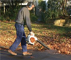 Man using noisy leaf blower