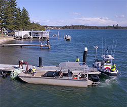 EPA officers on a jetty preparing to join the flood cleanup by boat