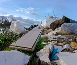 pile of illegally dumped rubbish on public