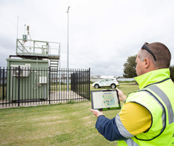 EPA officer reads data from air quality monitor station