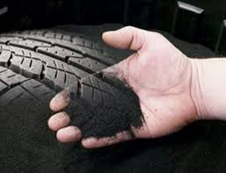 hand holding discarded industrial tyre