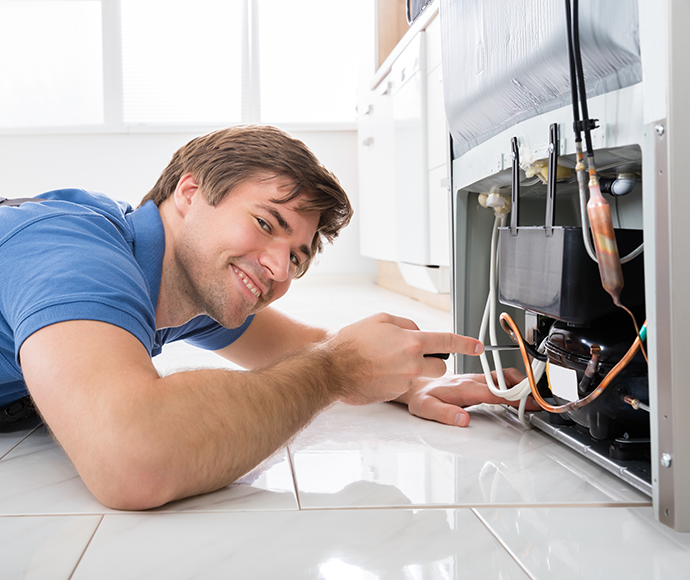 tradesman inspecting appliance