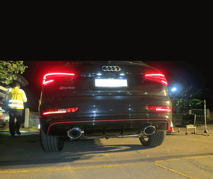 EPa officer testing car for noisy exhaust