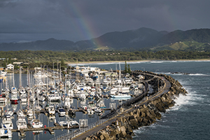 View onto sailing boats with a rainbow from Muttonbird Island Nature Reserve. Coffs Harbour, NSW.